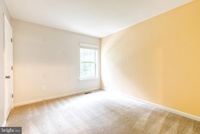 carpeted spare room with baseboards