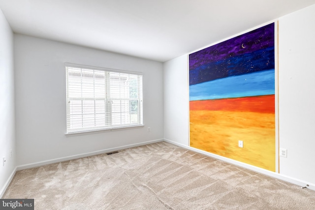 carpeted spare room with baseboards