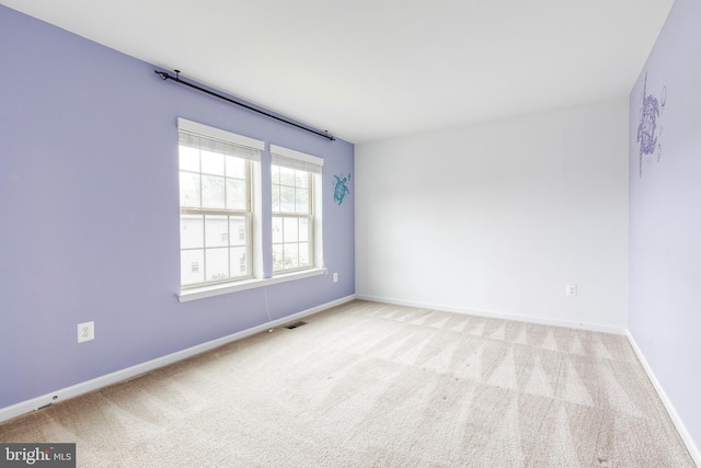 empty room with carpet flooring and baseboards
