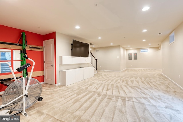 workout area with light carpet, baseboards, recessed lighting, and electric panel