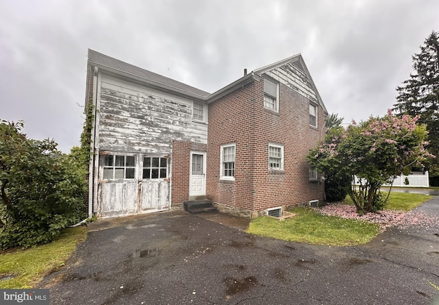 view of property exterior with entry steps and brick siding