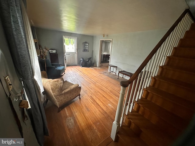 living room with wood finished floors and stairs