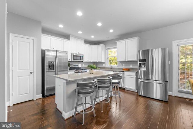 7820 Loblolly Way, Hanover, MD 21076 - kitchen with stainless steel appliances, white cabinetry, a center island, a sink, and dark wood-style floors