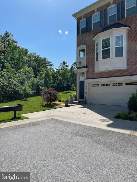 7820 Loblolly Way, Hanover, MD 21076 - view of front of home featuring a garage, concrete driveway, and brick siding