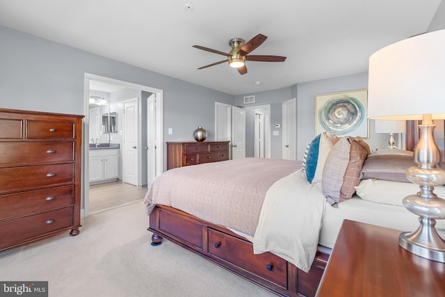 7820 Loblolly Way, Hanover, MD 21076 - bedroom featuring light colored carpet, connected bathroom, a sink, and a ceiling fan
