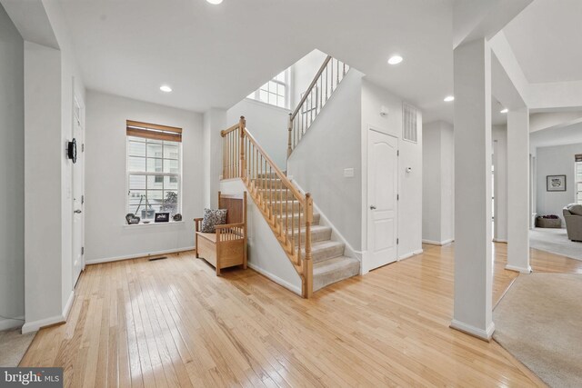 13551 Elysian Dr, Leesburg, VA 20176 - entrance foyer featuring light wood-style flooring, stairs, baseboards, and recessed lighting