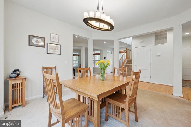 13551 Elysian Dr, Leesburg, VA 20176 - dining space featuring light carpet, recessed lighting, a chandelier, baseboards, and stairway