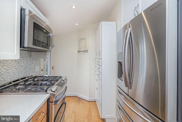 1616 S Oakland St, Arlington, VA 22204 - kitchen with appliances with stainless steel finishes, white cabinets, light wood-style floors, backsplash, and recessed lighting