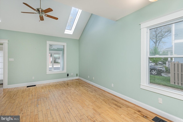 1616 S Oakland St, Arlington, VA 22204 - spare room featuring a ceiling fan, plenty of natural light, vaulted ceiling, a skylight, and hardwood / wood-style floors