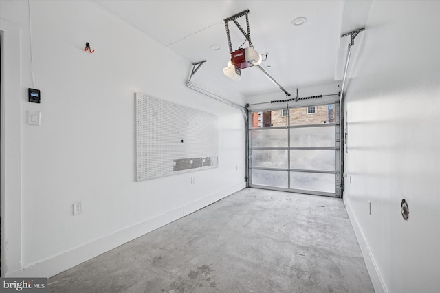 garage with a garage door opener and baseboards
