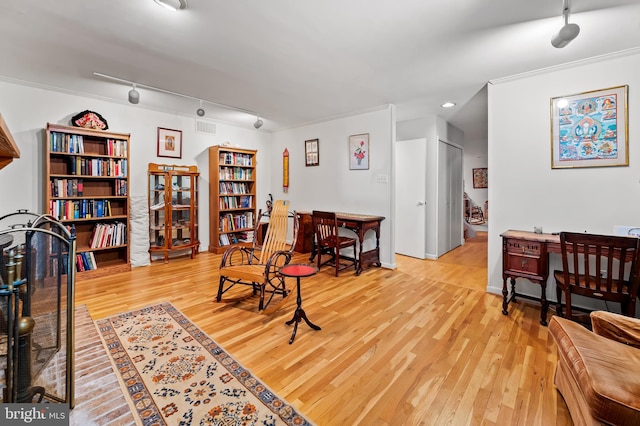 sitting room with wood finished floors, track lighting, and recessed lighting