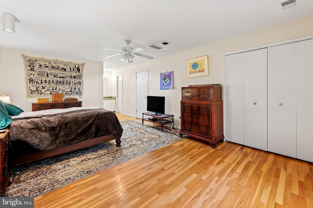 bedroom with wood finished floors, a closet, and ceiling fan