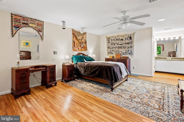 bedroom with light wood-style flooring, baseboards, ensuite bath, a ceiling fan, and recessed lighting