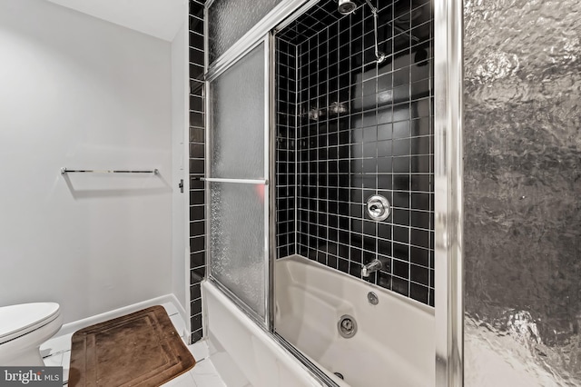 bathroom with toilet, combined bath / shower with glass door, and baseboards