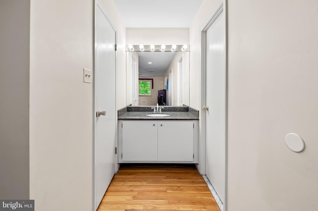 bathroom featuring wood finished floors and vanity