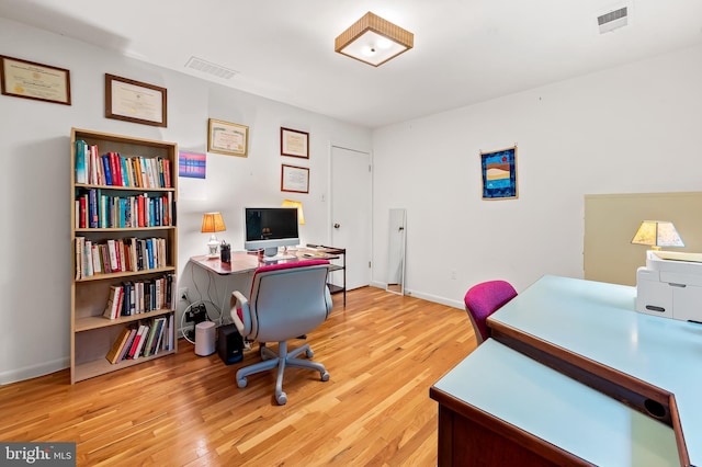 home office with wood finished floors and baseboards