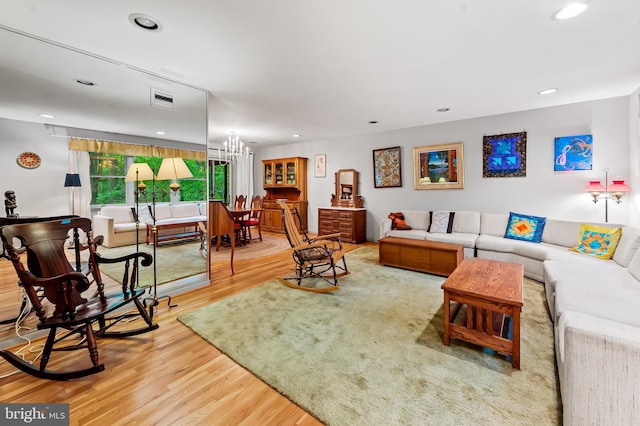 living area featuring wood finished floors, a chandelier, and recessed lighting