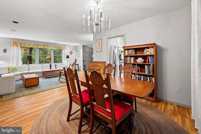 dining room featuring a chandelier, wood finished floors, and recessed lighting