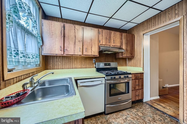 23 N Morley St, Baltimore, MD 21229 - kitchen featuring white dishwasher, gas stove, under cabinet range hood, a sink, and light countertops