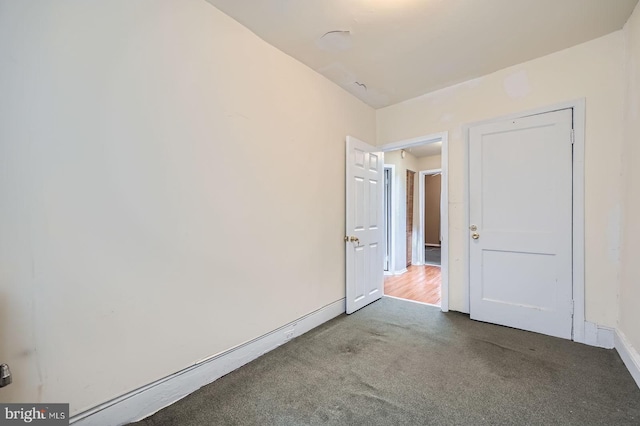 23 N Morley St, Baltimore, MD 21229 - carpeted empty room with baseboards