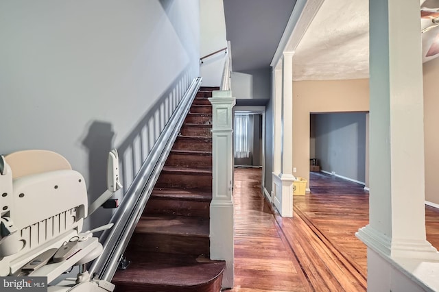 23 N Morley St, Baltimore, MD 21229 - staircase with wood finished floors, decorative columns, and baseboards