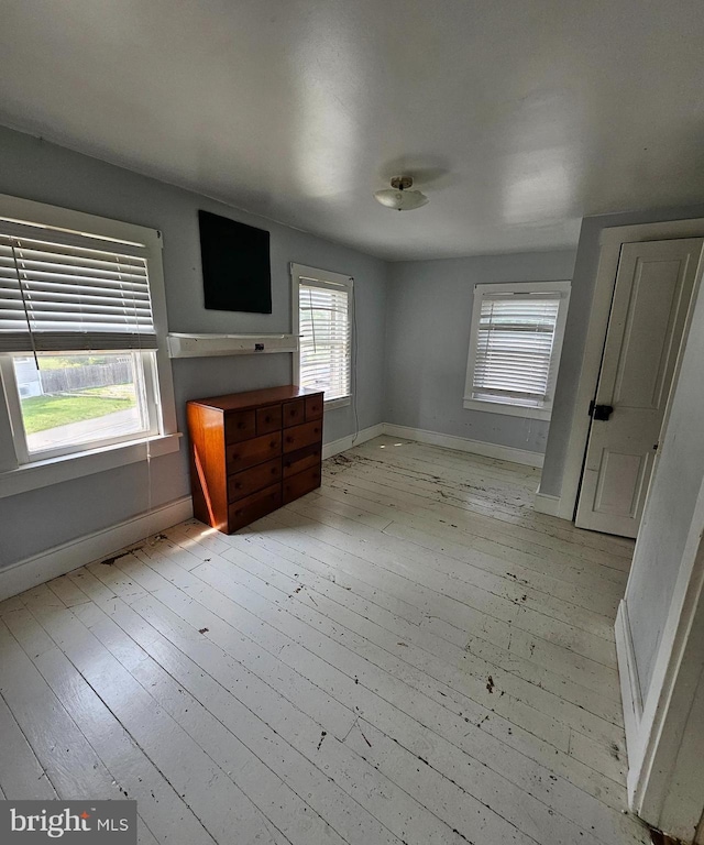 49 Front St, Wyoming, DE 19934 - unfurnished bedroom with light wood-style flooring and multiple windows