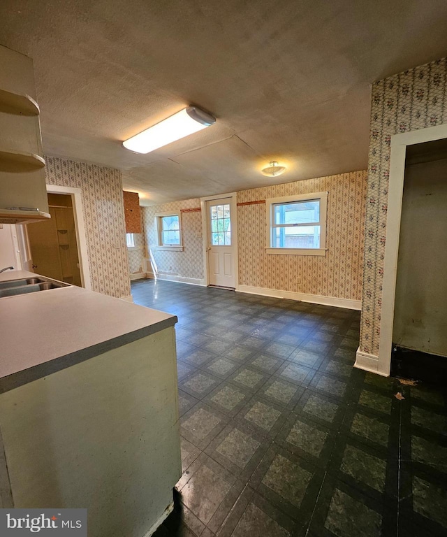 49 Front St, Wyoming, DE 19934 - below grade area featuring wallpapered walls and dark floors