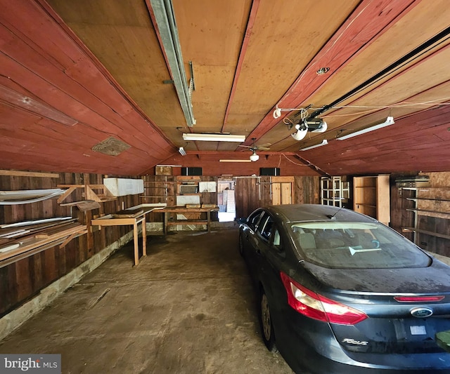 49 Front St, Wyoming, DE 19934 - garage featuring wood walls and a garage door opener
