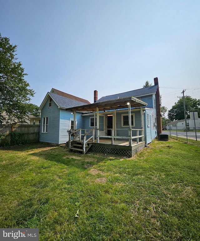 49 Front St, Wyoming, DE 19934 - rear view of house featuring a deck and a chimney