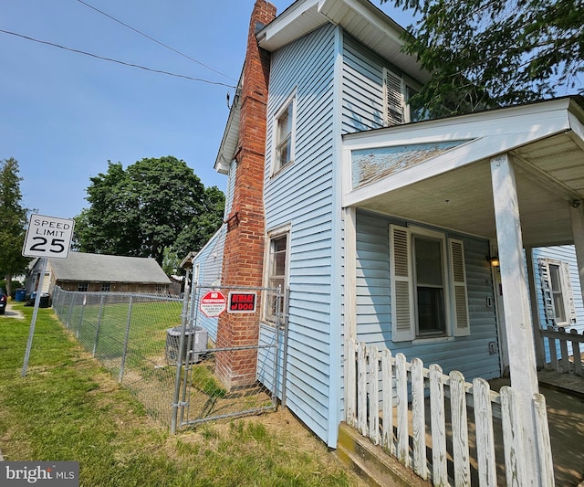 49 Front St, Wyoming, DE 19934 - view of property exterior featuring a chimney and covered porch