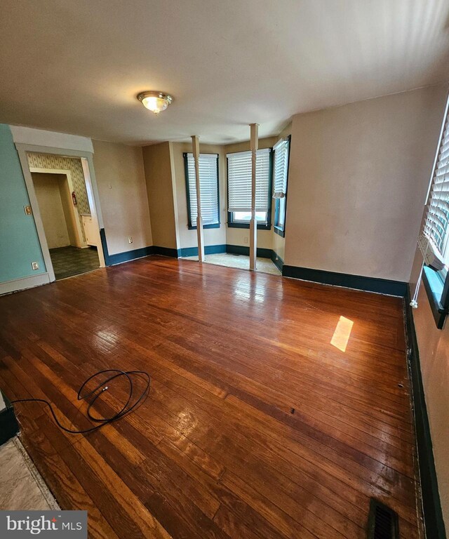 49 Front St, Wyoming, DE 19934 - empty room with wood-type flooring and healthy amount of natural light