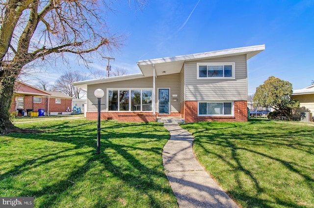 3302 Olympia Ave, Baltimore, MD 21215 - view of front of home featuring a front yard and brick siding