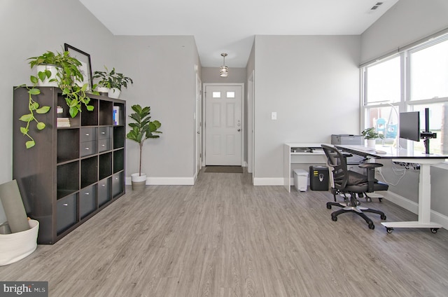 office area with wood finished floors, baseboards, and healthy amount of natural light
