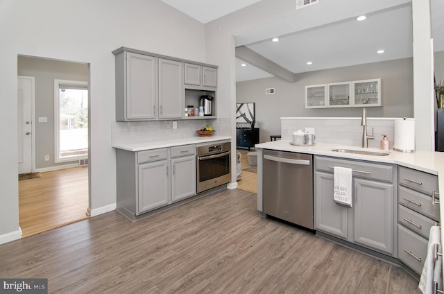 3302 Olympia Ave, Baltimore, MD 21215 - kitchen featuring gray cabinets, stainless steel appliances, a sink, tasteful backsplash, and recessed lighting
