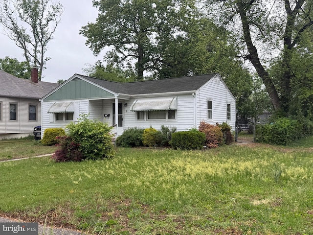 single story home with a front yard and board and batten siding