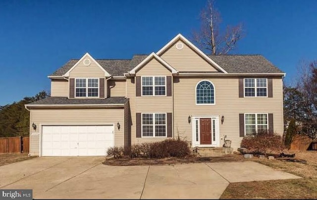 10400 Markby Ct, White Plains, MD 20695 - view of front of property with concrete driveway, a garage, and fence