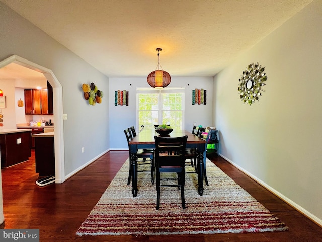 10400 Markby Ct, White Plains, MD 20695 - dining room with dark wood-style floors, arched walkways, and baseboards