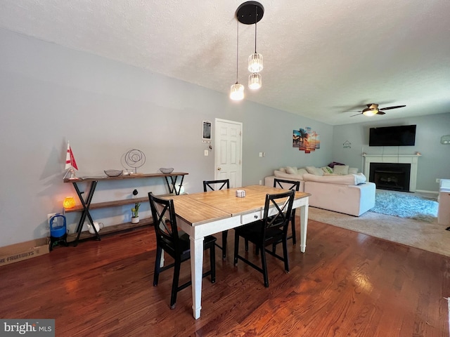 10400 Markby Ct, White Plains, MD 20695 - dining space featuring ceiling fan, wood finished floors, a fireplace, and a textured ceiling
