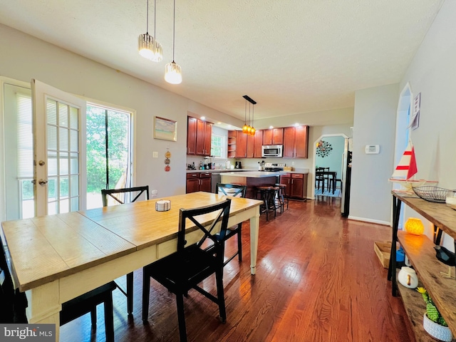 10400 Markby Ct, White Plains, MD 20695 - dining room with dark wood-style floors, arched walkways, french doors, a textured ceiling, and baseboards