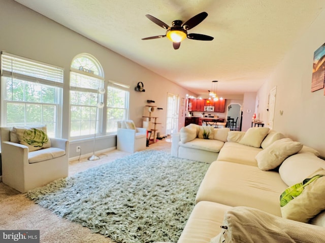 10400 Markby Ct, White Plains, MD 20695 - carpeted living area with a ceiling fan, a chandelier, and a textured ceiling