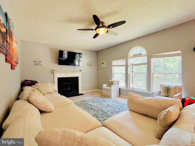 10400 Markby Ct, White Plains, MD 20695 - carpeted living area with a textured ceiling, ceiling fan, a fireplace with flush hearth, and baseboards
