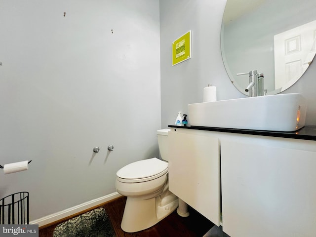 10400 Markby Ct, White Plains, MD 20695 - half bathroom with wood finished floors, toilet, baseboards, and vanity