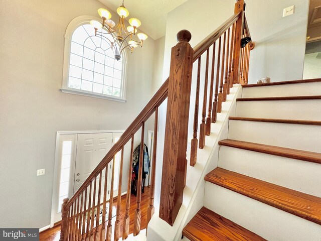 10400 Markby Ct, White Plains, MD 20695 - stairs featuring a chandelier and wood finished floors
