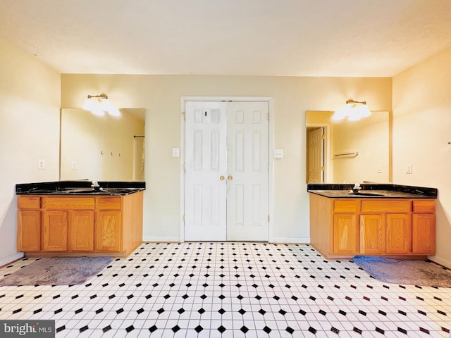 10400 Markby Ct, White Plains, MD 20695 - bathroom featuring baseboards and two vanities