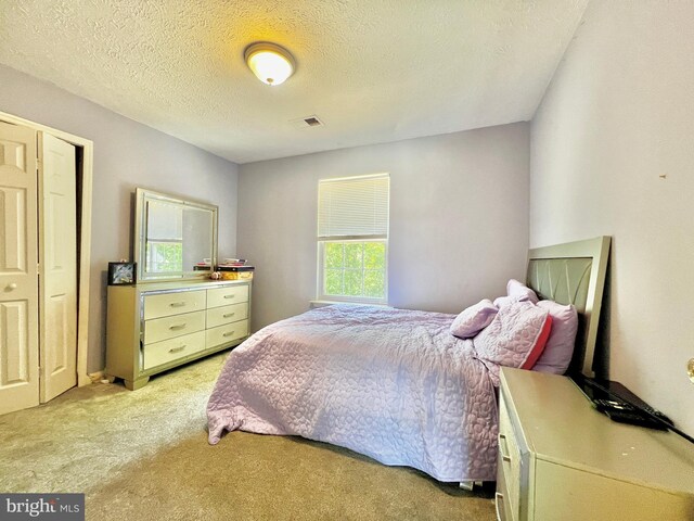 10400 Markby Ct, White Plains, MD 20695 - bedroom with light colored carpet and a textured ceiling