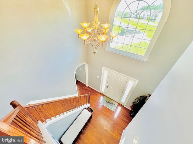 10400 Markby Ct, White Plains, MD 20695 - foyer featuring a chandelier, wood finished floors, a towering ceiling, and arched walkways