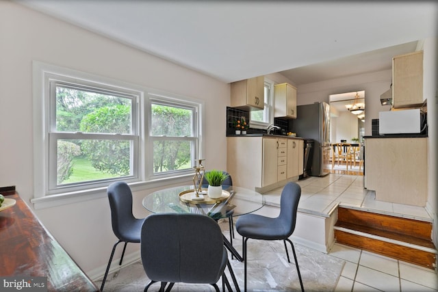 3702 Forest Grove Dr, Annandale, VA 22003 - dining area featuring a chandelier, light tile patterned floors, and baseboards