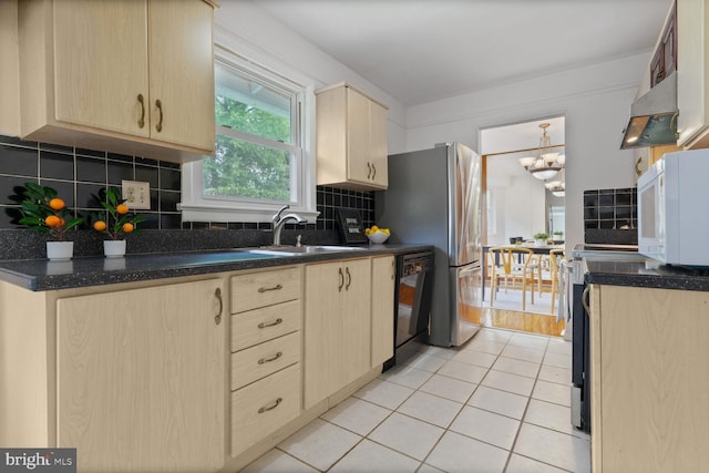 3702 Forest Grove Dr, Annandale, VA 22003 - kitchen with light brown cabinetry, range hood, dishwasher, and a sink