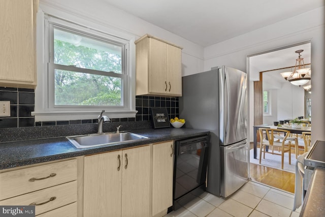3702 Forest Grove Dr, Annandale, VA 22003 - kitchen with a sink, black dishwasher, light brown cabinetry, dark countertops, and plenty of natural light