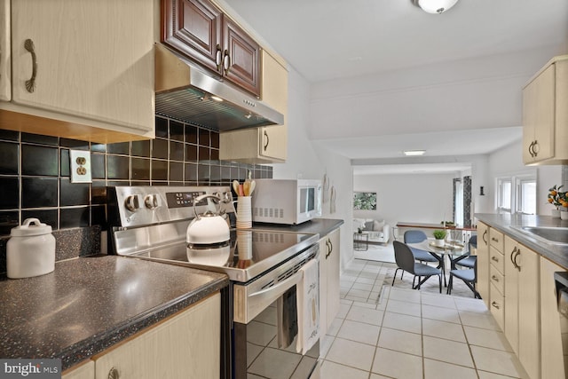 3702 Forest Grove Dr, Annandale, VA 22003 - kitchen with stainless steel range with electric cooktop, extractor fan, white microwave, light tile patterned flooring, and tasteful backsplash